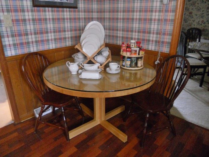 Round light wood kitchen table with glass top