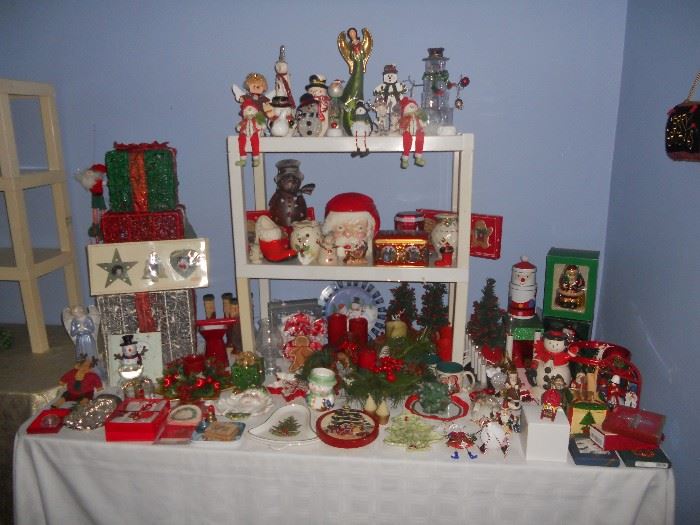One of 3+ tables of Christmas and other holiday decorations incl.  Byers carolers, ceramic Christmas trees, and ornaments by Wedgewood, Lenox, etc.