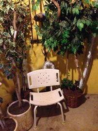 Various fake trees, medical chair and walker