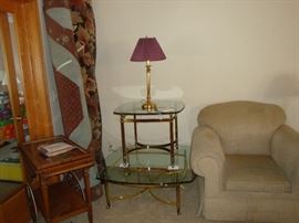 Brass glass top tables, Area rugs. tea cart, Stuffed chair