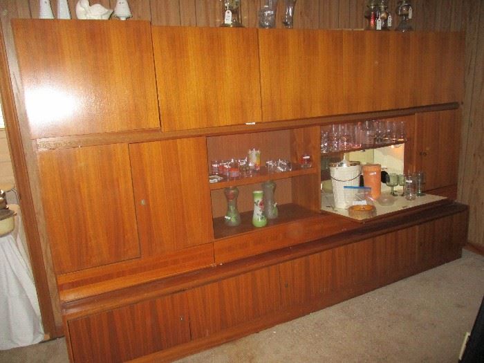 Danish Modern wall unit with a drop down bar and storage from top to bottom.  Three pieces.  Teak veneer purchased in Germany in 1969.  We can provide resources to help move it!