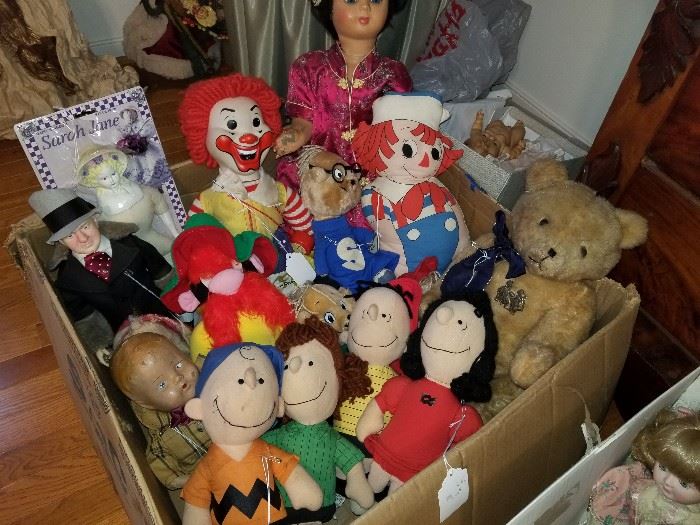 stuffed toys/dolls, including Charlie Brown, Ronald McDonald, old teddy bear, Raggedy Andy, WC Fields