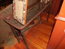 Leather, metal and glass table. Button frame