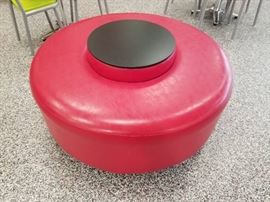 Round padded seat with table area in middle