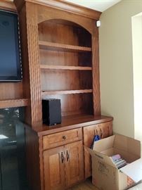 Large built-in cherry wood entertainment center.  Cabinetry and doors 