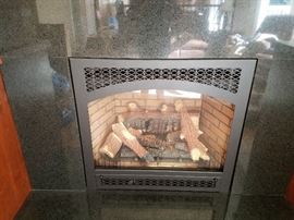 Gas fireplace insert with remote and stone surround and hearth.  Fireplace is 34 tall x 37 wide.  