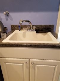 Laundry room sink with granite top. and sink
