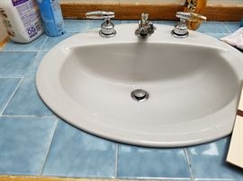 Upper bath sink.  Blue tile on vanity