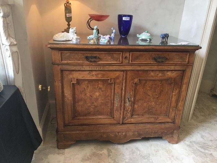 Late 1800s burl wood chest ($945) purchased from antique dealer in Charleston; assorted Herend porcelain pieces, custom blown glass piece; Kosta Boda vase; Green onyx table lamp ($188)