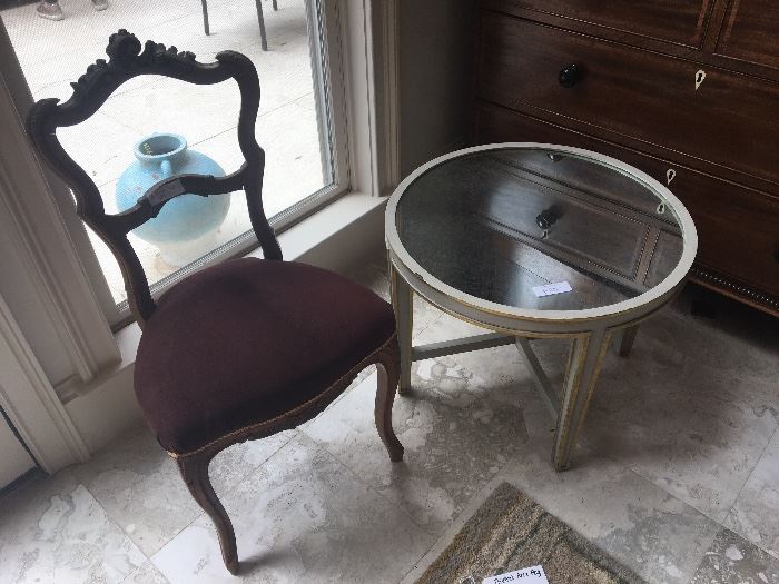 Mirrored side table with gilt accents ($110); antique chair with carved wood scrolls ($380)