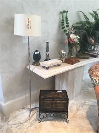 Palmer Hargrave chrome floor lamp ($320/each-2 available); Travertine console table ($795); wooden box on stand ($48); assorted home decor items, silk plant, faux flower arrangement 