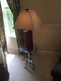 Red-leathered table lamp ($35); metal occasional/side table ($55)