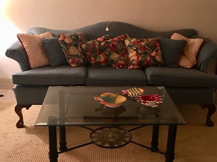 Chippendale-style camel back sofa in super condition with ball and claw feet - glass and metal coffee table - we have dozens of interesting pillows, too