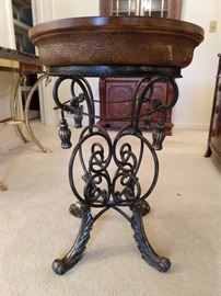 Fancy wrought iron base side table.