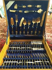 144-piece set of brass flatware, in mahogany chest, from Sri Gang Thai jewelry store, Bangkok.                                Some people go to Bangkok for other things, she went for flatware?