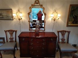One of a pair of 1940's vintage Drexel New Travis Court mahogany buffets, flanked by a pair (there are 10 of these side chairs) of vintage Henredon carved mahogany ball/claw dining chairs, vintage Italian gilt wood mirror, lustrously lit by a pair of Italian regency wall sconces, with plenty o' hangy, shiny things.