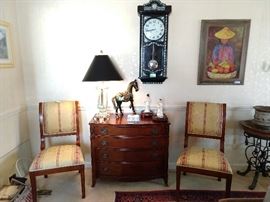 Vintage 1940's Drexel New Hampton Court 4-drawer mahogany bachelor's chest, with heavy crystal table lamp, flanked by a pair (6 available) of comfy mahogany/upholstered dining side chairs. MOP inlaid wall clock and listed artist Asian market scene