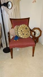 UPHOLSTERED ARM CHAIR WITH DECORATIVE PILLOWS.