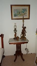 WALNUT AND MARBLE VICTORIAN ERA EAST LAKE PARLOR TABLE. GILT PUTTI LAMP. PUTTI BASE KEROSENE LAMP, CAST IRON FLORAL BASKET DOOR STOP.