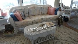 WICKER SOFA AND COFFEE TABLE. LARGE RAG RUG.