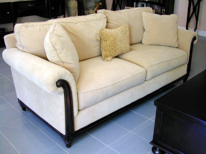 Sofa/Couch by Bauhaus with wooden carved accents/frame. In excellent shape. Beige/cream color with pillows.
