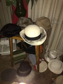 Great selection of hats on a mid-century modern side table