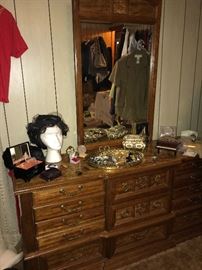 Dresser with mirror, wig and assorted jewelry items
