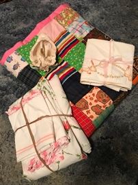 Lots of linens including this handmade quilt and hand-crochet trimmed pillowcases