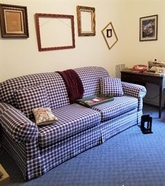 Sleeper sofa. Sewing machine and cabinets. Photo and art frames
