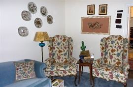 Tall wing back chairs, framed embroidery, plate display, wood side tables 