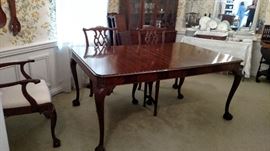 This Antique table has 3 leaves and table pads. There are 2 armchairs and 4 regular chairs. The chairs have cream white seats