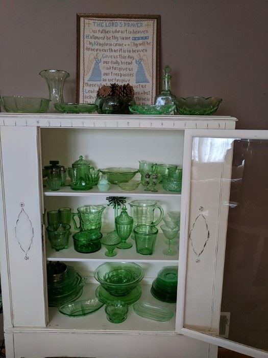 The cabinet in this picture is not for sale, however the  stunning green glass is!