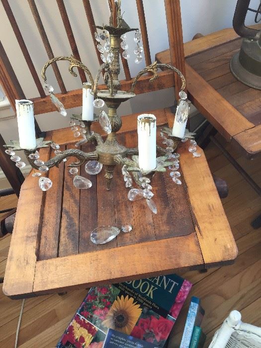 antique chandelier on one of the four wooden folding chairs