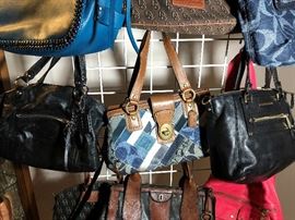 Dozens of designer purses including Coach, Michael Kors, Dooney and Bourke, Fossil, and more
