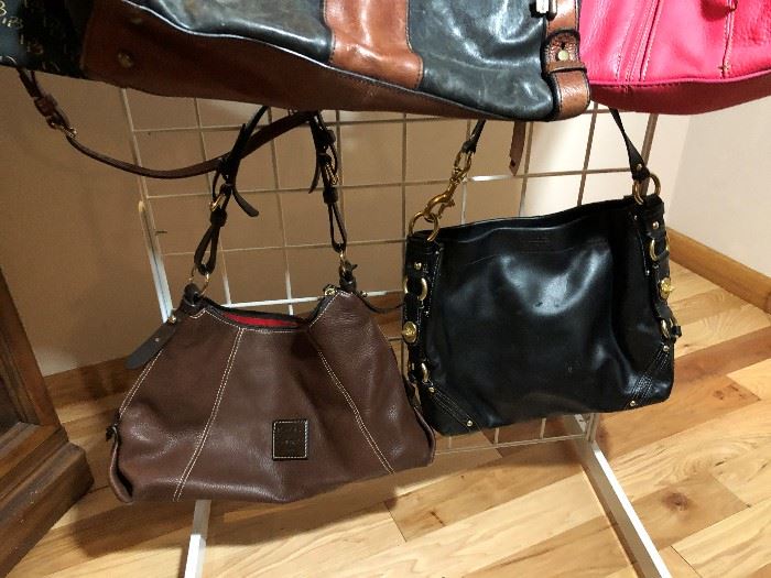 Dozens of designer purses including Coach, Michael Kors, Dooney and Bourke, Fossil, and more