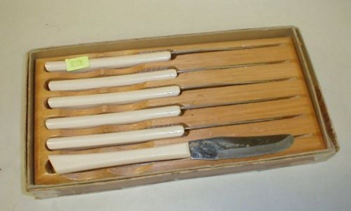 Older Set of Cattaraugus steak knives with wood holder.  On blade dented