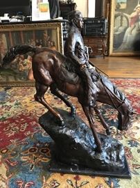 Large Bronze Sculpture After Frederic Remington (1861-1909) | On a solid marble base | Statue is Entitled The Mountain Man | Statue Has the title of the of the work on its base with a brass plaque | Dimensions: Approx. 29″ H