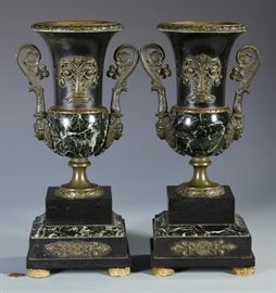 Pair of 19th Century French urn garniture vases with green marble lower body, bronze top, bronze mounted foliate and mask handles, and bronze feet – all on a green marble stepped base with bronze mounts and feet | Very nice dark patina | Measures 13 1/4″ H | Very Good Condition.
Dimensions: 13.25" H
Medium: green marble lower body, bronze top, bronze mounted foliate and mask handles, and bronze feet - all on a green marble stepped base with bronze mounts and feet
Date: 19th Century
Condition Report: Very good condition