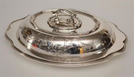 Reed & Barton Sterling Silver Covered Serving Dish | 37.63 ozt; 1067 grams | Measures 4.5" tall x 10.75" x 7.5" | The hallmark is the silversmiths eagle/R/lion mark, which was used well prior to 1928 when Reed & Barton began using date marks.
Dimensions: Measures 4.5" tall x 10.75" x 7.5"; 37.63 ozt; 1067 grams
Artist or Maker: Reed & Barton
Medium: Sterling Silver
Date: 1889 - 1915
Condition Report: Very Good.
Notes: Reed & Barton is a prominent American silversmith manufacturer based in the city of Taunton, Massachusetts, operating between 1824 and 2015. Its products include sterling silver and silverplate flatware. The company produced many varieties of britannia and silver products since Henry G. Reed and Charles E. Barton took over the failing works of Isaac Babbitt in Taunton. During the American Civil War, Reed & Barton produced a considerable quantity of weapons for Union Army soldiers and officers. In 1928, Reed & Barton merged with silversmith Dominick & Haff. Reed & Barton w