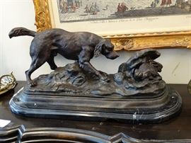 Large Bronze Sculpture of a Hunting Dog or Hound | Depicts the hound smelling the ground in search of a ----- seen hiding in a fallen tree trunk | Bronze Statue on Marble - Hunting Dog Size : 28" L x 11" T
Dimensions: 28" x 13.25" x 13"
Medium: Bronze
Condition Report: Excellent