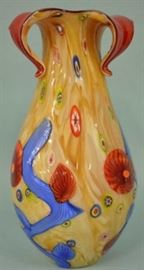  16.5″ x 8.5″ | Cristalleria Stile | D Arte Murano | Millefiori Vase Stunning Cristalleria Stile DÁrte Italian Murano art glass millefiori vase. The vase has a base color of beige with blue, red, green, yellow & white millefiori with blue accents and cased inside with deep red glass. The vase is in great condition with the original sticker.
Dimensions: 16.5" x 8.5" x 8.5"
Artist or Maker: DÁrte Murano Millefior
Medium: Cristalleria Stile
Condition Report: Excellent