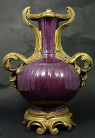 Castilian bronze mounted porcelain urn. Wine exterior with white crackle glaze interior. Marked to underside. Measures 15" (38cm) height.
Dimensions: 15" H
Medium: Bronze mounted porcelain