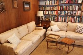 Leather sofa & matching love seat, mid-century nesting tables, brass table lamp. Hundreds of art, entertainment and historical books and novels, including some first editions.