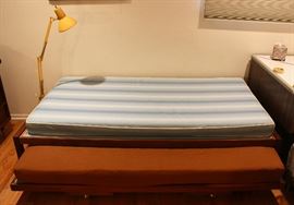 Single-size trundle bed, Mid-Century clamp lamp.