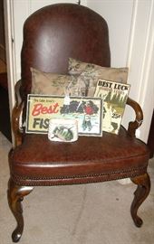 Nice leather chair and fishing signs, fishing rods and reel. 