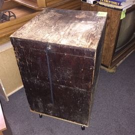 This is a rolling wooden box the lid opens up for storage. Can hold about anything