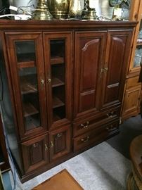 Entertainment center mahogany color glass doors lots of storage. The dimensions are 58 inches long, 22 inches deep, and 59 inches tall