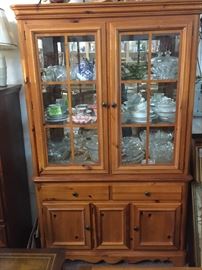 This beautiful china cabinet is made of knotty pine it is lighted with glass shelves. And is in one piece 