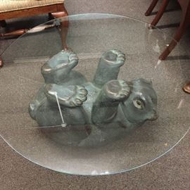  Unique coffee table with a composite bear base and glass top. 3 foot in diameter 