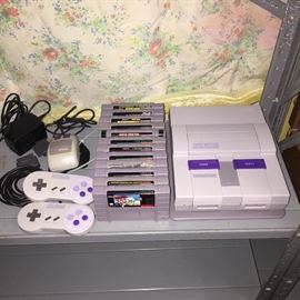 Super Nintendo gaming system complete with two paddles, mouse, connections. There are 12 games available
Power rangers the fighting in addition, double dragon five, Frogger, super Mario world, miss Pac-Man, world heroes, Mario Paint, Tetris attack, Hey punk! Are you Tuff E Nuff?, super high impact, Street fighter ll turbo, the rise of the robots